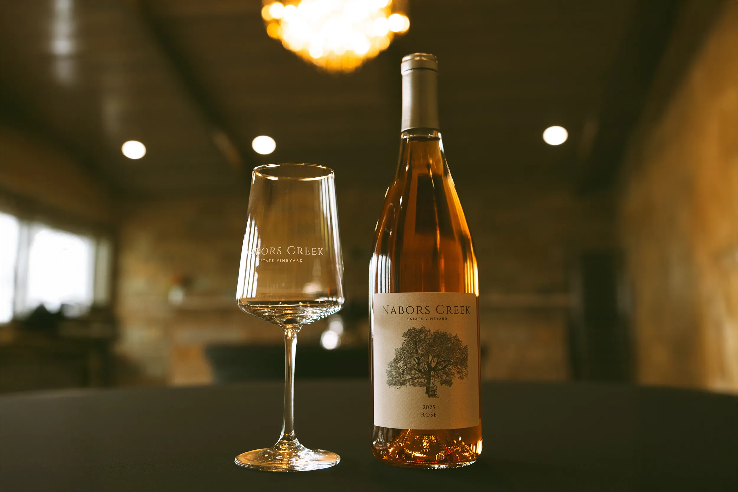 Nabors Creek wine bottle and glass on a table