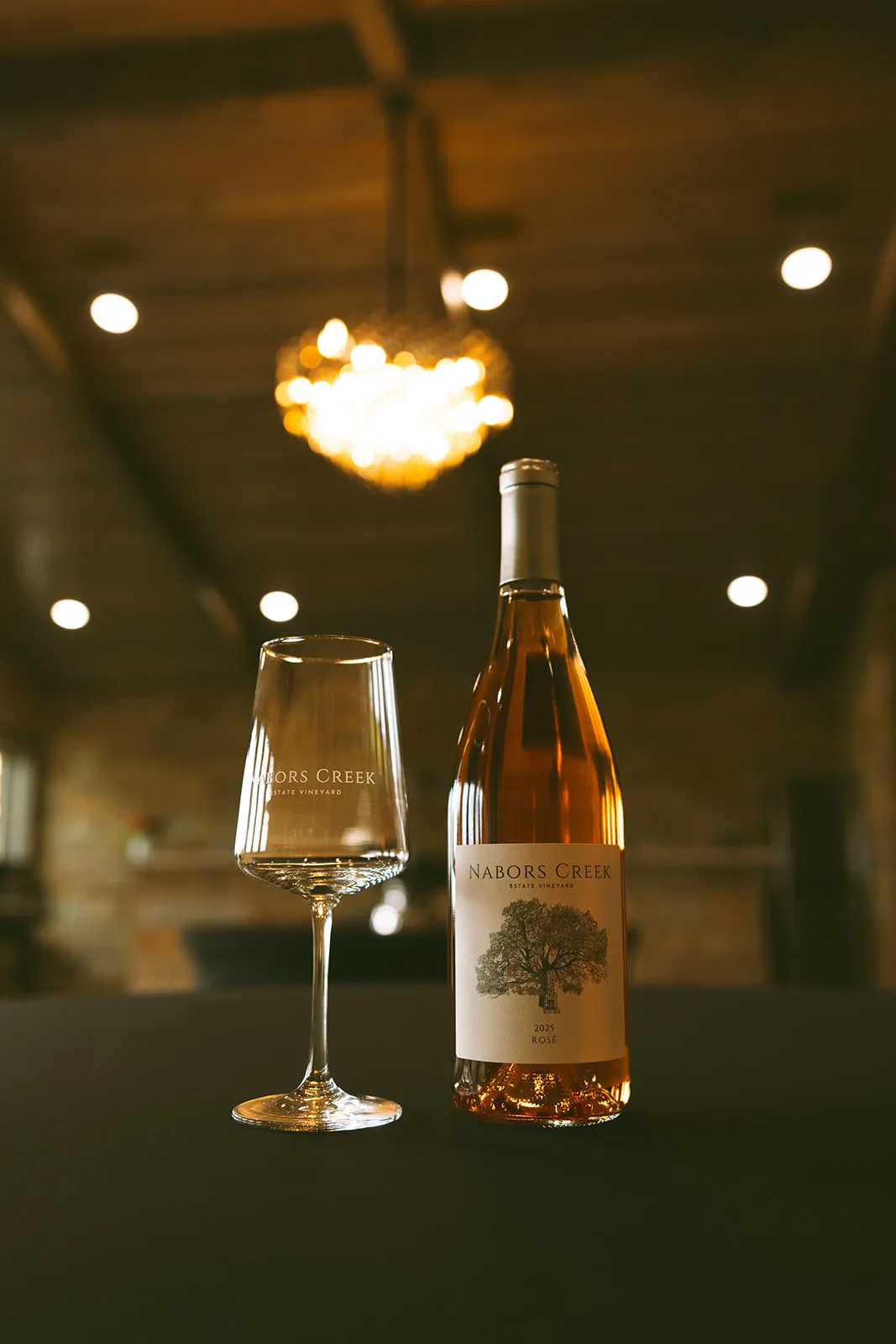 Nabors Creek wine bottle and glass on a table