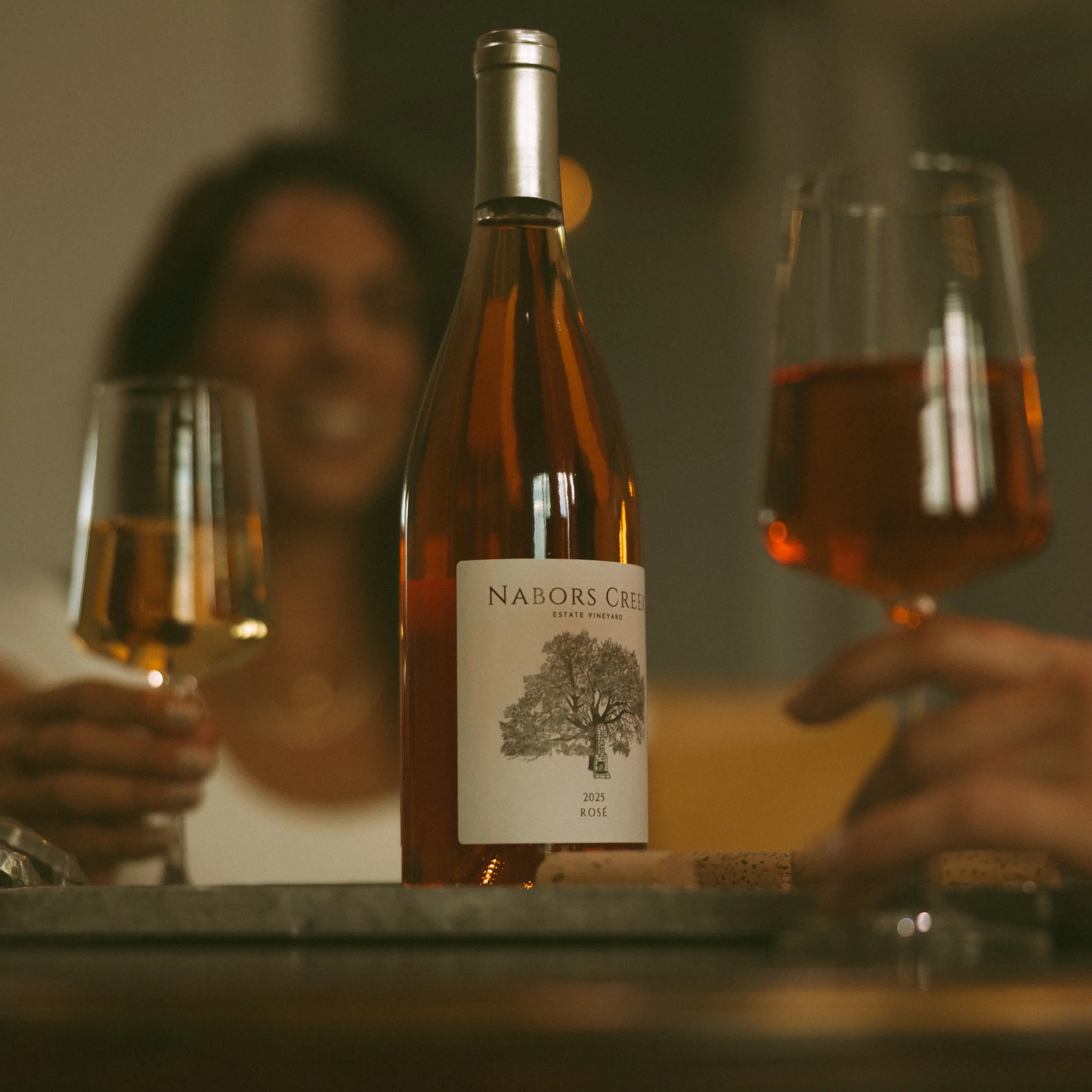Two people toasting glasses of Nabors Creek Wine