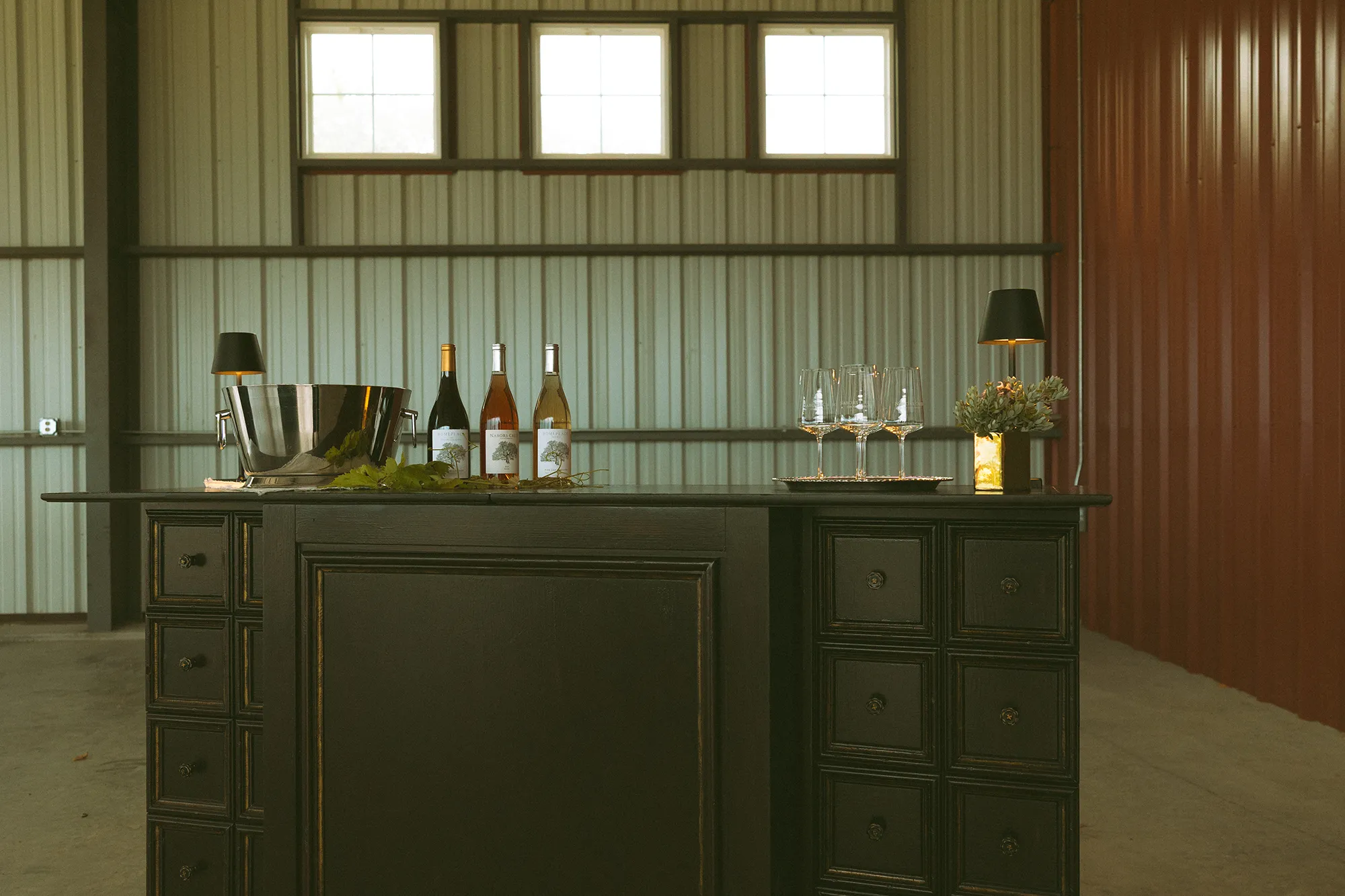 Wine bottles and glasses set up for event at Nabors Creek